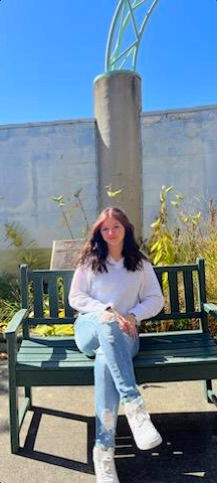 Malia is registered to the contest to win money with this photo: bench, blue, denim, electric_blue, fun, fur, grass, happy, jeans, joy, leisure, outdoor_furniture, person, plant, portrait_photography, sitting, sky, travel, wood