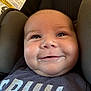Evan is registered to the contest to win money with this photo: baby, infant, face, smile, drool, car_seat, child, cute, close_up, clothing, head_support, seat, seatbelt, young_child, expression, portrait, comfort, indoors, soft_texture, happy