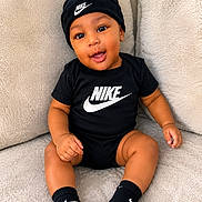 Camiri joined the competition — help win amazing prizes! baby, child, nike, black_clothing, black_hat, black_socks, smiling, sitting, indoor, couch, plush, comfortable, cute, happy, person, portrait, infant, fashion, logo, apparel