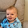 baby, child, smiling, blue_shirt, patterned_shirt, popsicle_print, cushion, chair, seated, happy, portrait, indoor, cute, infant, young_child, short_hair, face, eyes, mouth, buttoned_shirt
