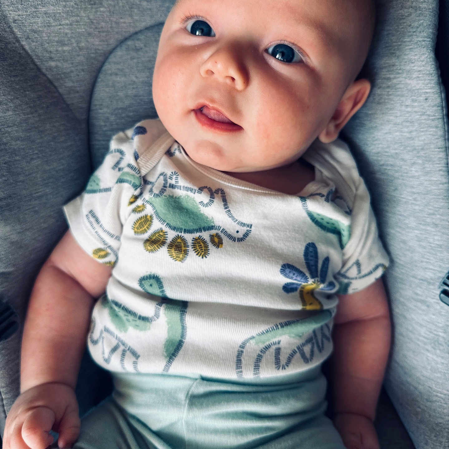 Cameron is registered to the contest to win money with this photo: baby, bodypart, clothing, cushion, face, finger, furniture, hand, happy, head, homedecor, newborn, pants, person, photography, portrait, sitting, sleeve, smile, t_shirt