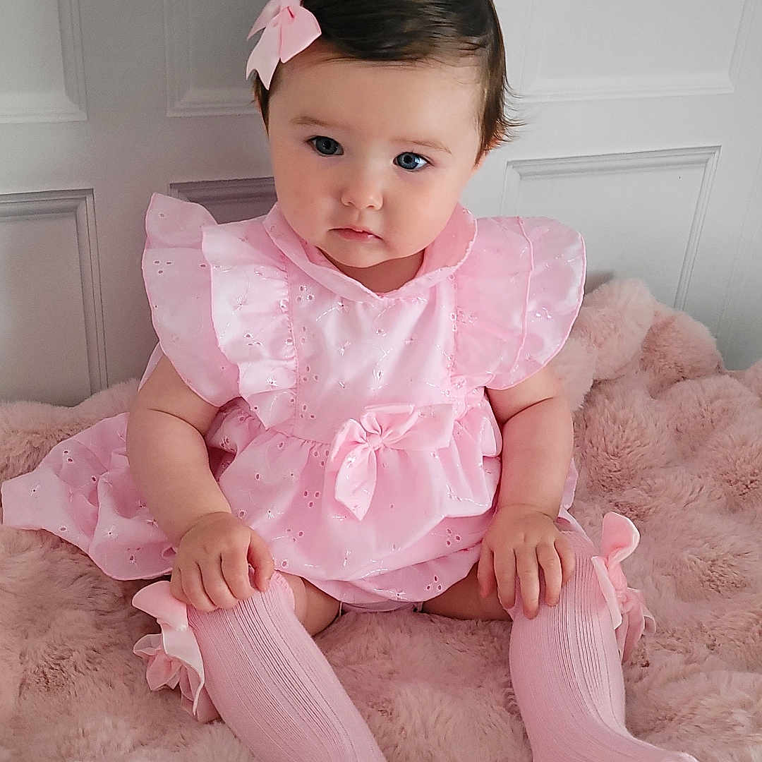 Everleigh is registered to the contest to win money with this photo: baby, bodypart, clothing, costume, dress, face, finger, footwear, hand, happy, hardwood, head, hosiery, person, photography, portrait, shoe, sitting, smile, sock