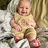 baby, smiling, infant, blanket, couch, clothing, happy, indoors, portrait, cute, child, person, feet, hand, cozy, soft, home, relaxed, sitting, comfort