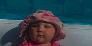 Nova joined the competition — help win amazing prizes! baby, child, pool, pink_clothing, hat, sunglasses, outdoor, summer, water, swimwear, infant, sunhat, toy, nature, trees, backyard, cute, sitting, person, leisure