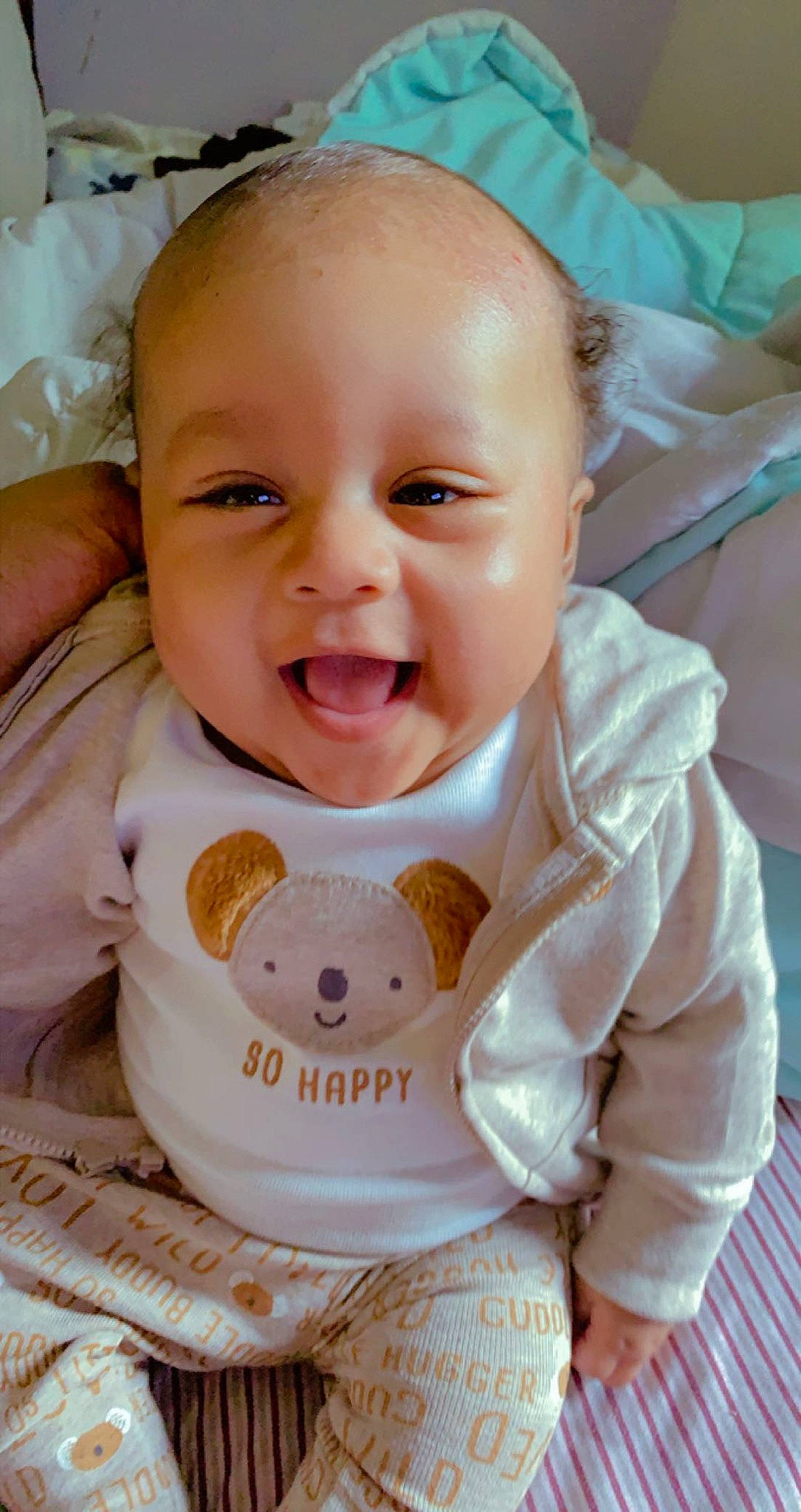 Kyng is registered to the contest to win money with this photo: baby, baby_toddler_clothing, bib, cheek, chin, dress, eye, face, happy, head, iris, lip, mouth, neck, nose, person, skin, sleeve, smile, textile