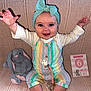 Cecelia joined the competition — help win amazing prizes! baby, child, smiling, headband, pastel_colors, striped_clothing, plush_toy, bunny, milestone_card, sitting, raised_arms, cute, indoor, blanket, happy, portrait, infant, clothing, playful, person
