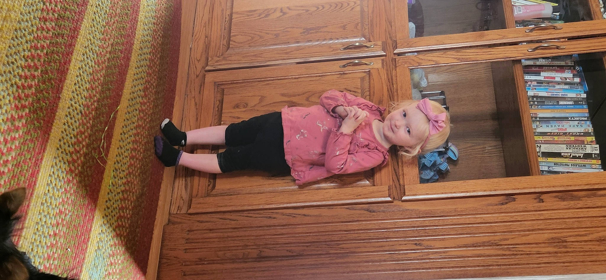 Alia is registered to the contest to win money with this photo: baby_toddler_clothing, child, door, floor, flooring, fun, hardwood, headwear, human_body, joy, mammal, person, pink, plank, plywood, room, sitting, smile, toddler, varnish