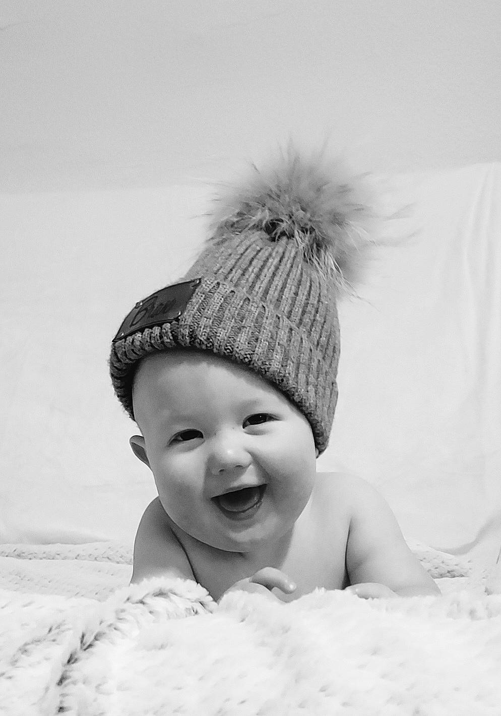 Braxton joined the competition — help win amazing prizes! baby, beach, beanie, cap, child, comfort, face, fashion_accessory, flash_photography, fun, fur, happy, headgear, headwear, knit_cap, monochrome, monochrome_photography, person, sand, smile