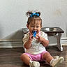 Amelia is registered to the contest to win money with this photo: blue_bow, child, cute, floor, happy, indoor, metal_bowls, person, pet_feeder, pigtails, pink_shorts, playful, sitting, smiling, toddler, toy, wall, white_shirt, white_shoes, wooden_floor