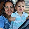Amelia is registered to the contest to win money with this photo: baby, blue_clothing, car, casual, child, cute, daylight, earrings, glasses, hair, happy, interior, person, portrait, seat, smile, steering_wheel, toddler, window, woman