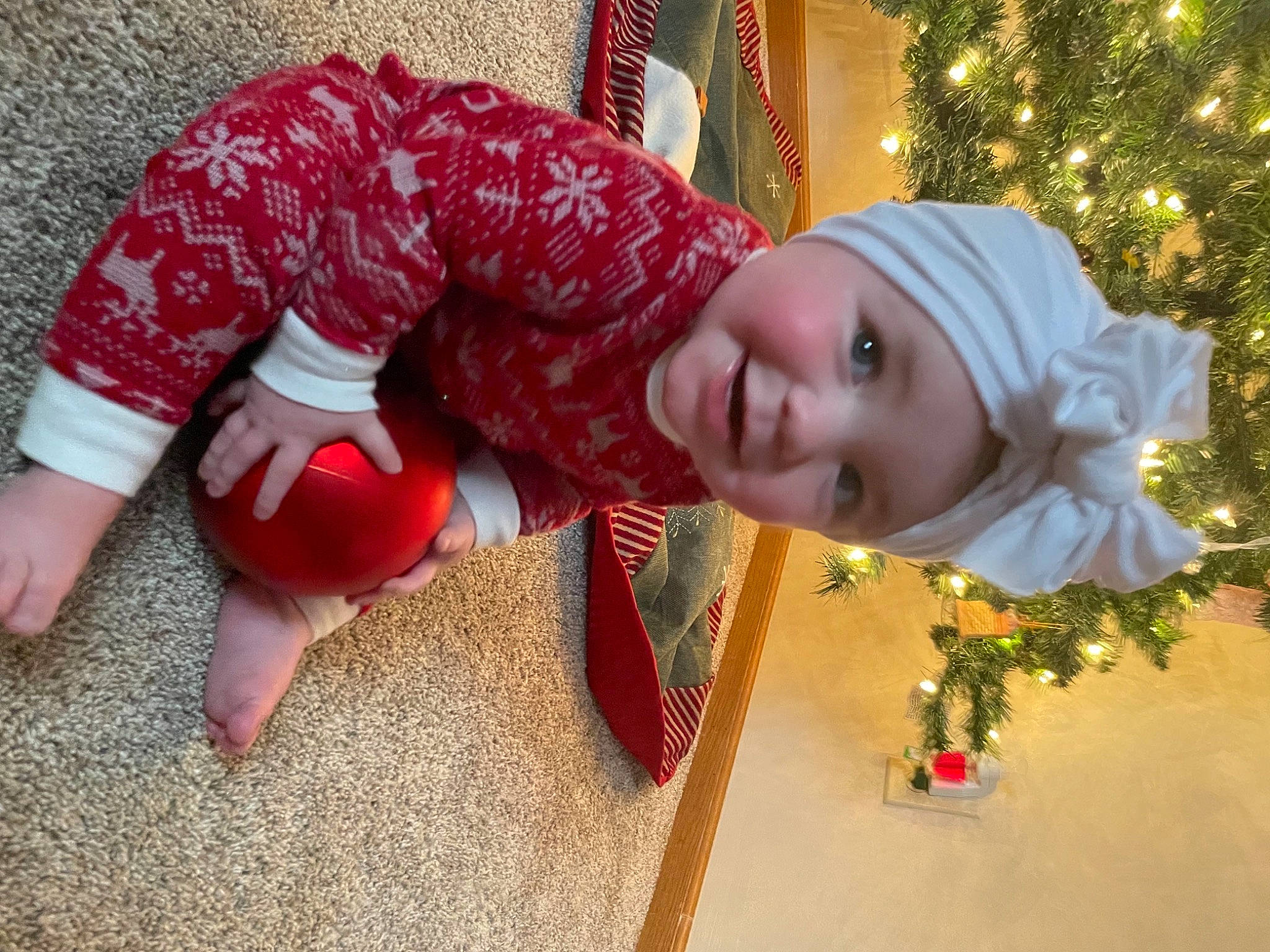 Oakley is registered to the contest to win money with this photo: child, christmas, christmas_decoration, christmas_ornament, christmas_tree, event, face, facial_expression, fictional_character, fun, happy, head, headwear, holiday, holiday_ornament, human_body, ornament, person, plant, smile