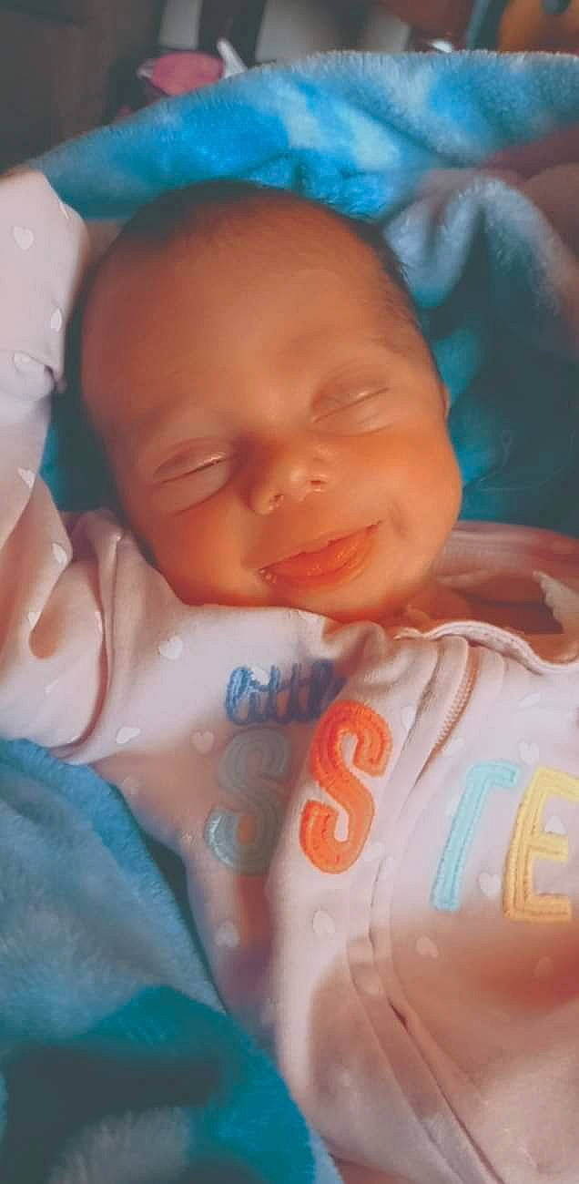 Lalia is registered to the contest to win money with this photo: azure, baby, baby_products, baby_toddler_clothing, bedtime, cheek, child, chin, comfort, finger, forehead, happy, iris, linens, mouth, nose, orange, person, skin, smile