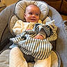 Carson joined the competition — help win amazing prizes! baby, infant, child, smiling, portrait, seated, bouncer, baby_chair, blanket, striped_blanket, cushion, indoor, home, warm_lighting, clothing, head, face, happy, relaxed, photography