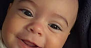 Carson joined the competition — help win amazing prizes! baby, child, infant, smiling, happy, portrait, face, eyes, indoor, blanket, clothing, onesie, cartoon, colorful, close_up, head, sitting, cozy, photography, adorable