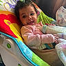 Sariyah joined the competition — help win amazing prizes! baby, bottle, smiling, curly_hair, baby_rocker, colorful, blanket, indoor, cozy, child, feeding, milk, cute, happy, infant, soft_lighting, pink_clothing, toddler, seat, comfort