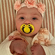 Olivia-Rose is registered to the contest to win money with this photo: baby, bodypart, cap, clothing, couch, cushion, face, finger, flower, furniture, hand, hat, head, homedecor, newborn, person, petal, photography, plant, portrait