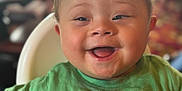 Avery-Ray joined the competition — help win amazing prizes! baby, child, smile, happy, green_shirt, blanket, high_chair, face, infant, indoors, cute, young, portrait, person, expression, seated, furniture, mohawk_hair, cheerful, closeup