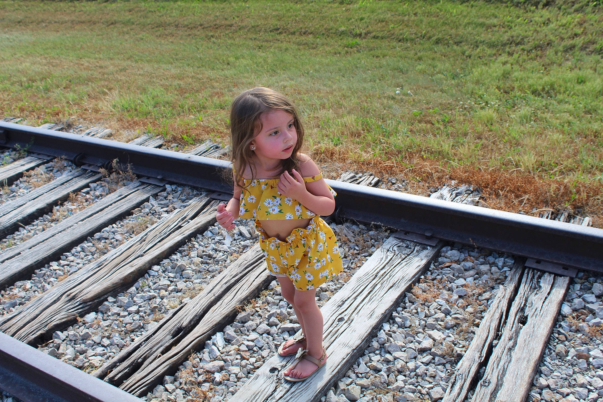 Natalia is registered to the contest to win money with this photo: child, composite_material, fun, happy, leaf, leisure, metal, people_in_nature, person, plant, railway, rolling, rubble, steel, street_fashion, thigh, toddler, track, transport, travel