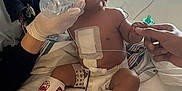 Elena Rose joined the competition — help win amazing prizes! baby, hospital, medical_equipment, caregiver, mask, gloves, feeding_bottle, diaper, bandage, monitoring_wires, hand_holding, bed, medical_tape, infant, patient, healthcare, treatment, child, medical_care, person