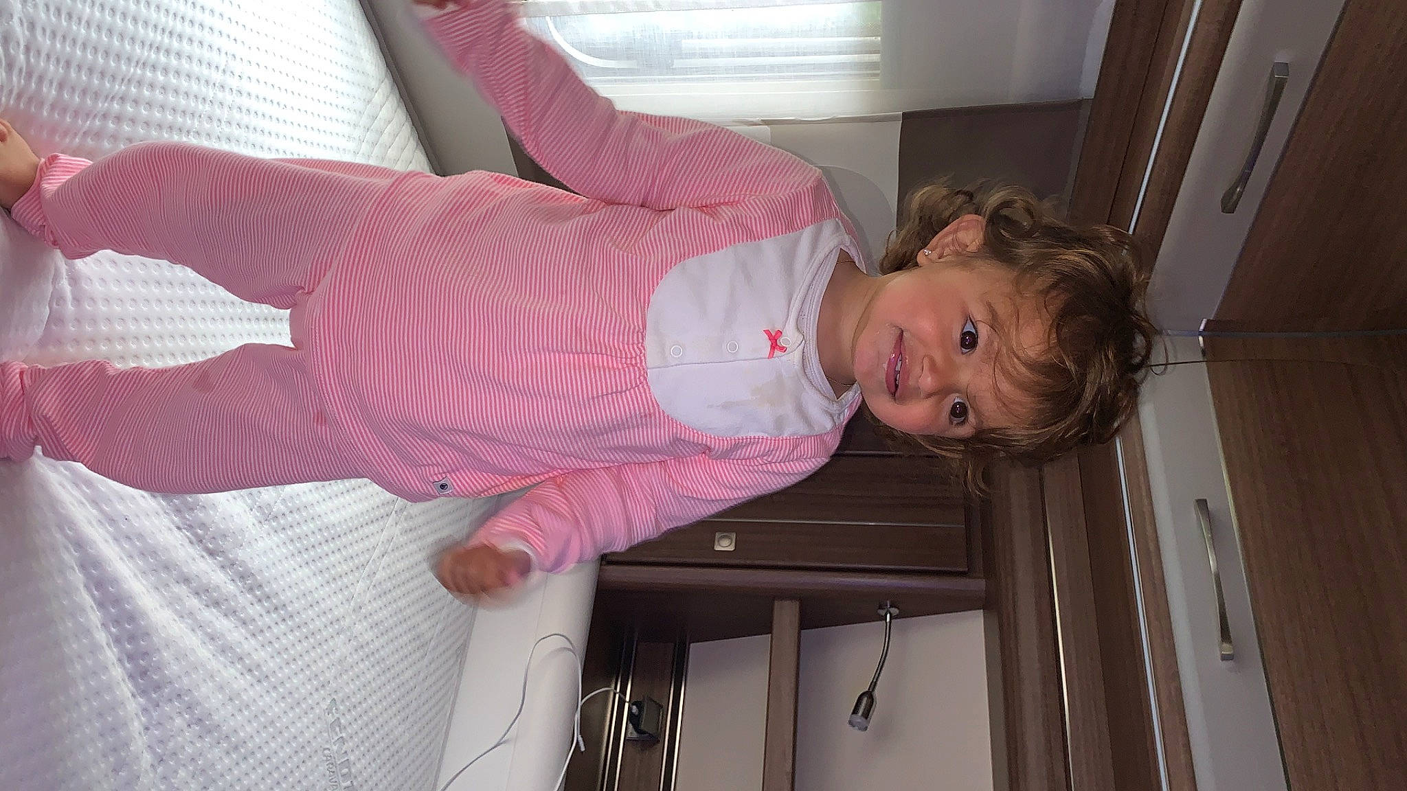 Amy participe au concours pour gagner de l'argent avec cette photo : arm, baby, baby_products, baby_toddler_clothing, bedding, child, comfort, eye, face, flooring, fun, head, joy, leg, linens, magenta, pattern, person, pink, room