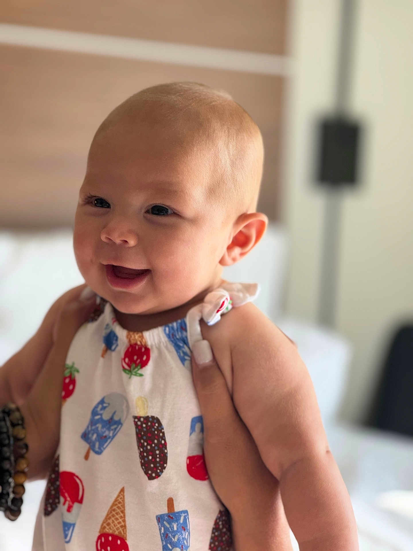 Haven is registered to the contest to win money with this photo: baby, child, smiling, face, person, clothing, pattern, ice_cream, popsicle, indoor, soft_light, hand, holding, happy, cute, infant, head, skin, apparel, young