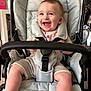 baby, smiling, stroller, child, happy, infant, seat, clothing, indoor, person, cute, expression, comfort, young, portrait, sitting, face, baby_girl, baby_boy, infant_clothing