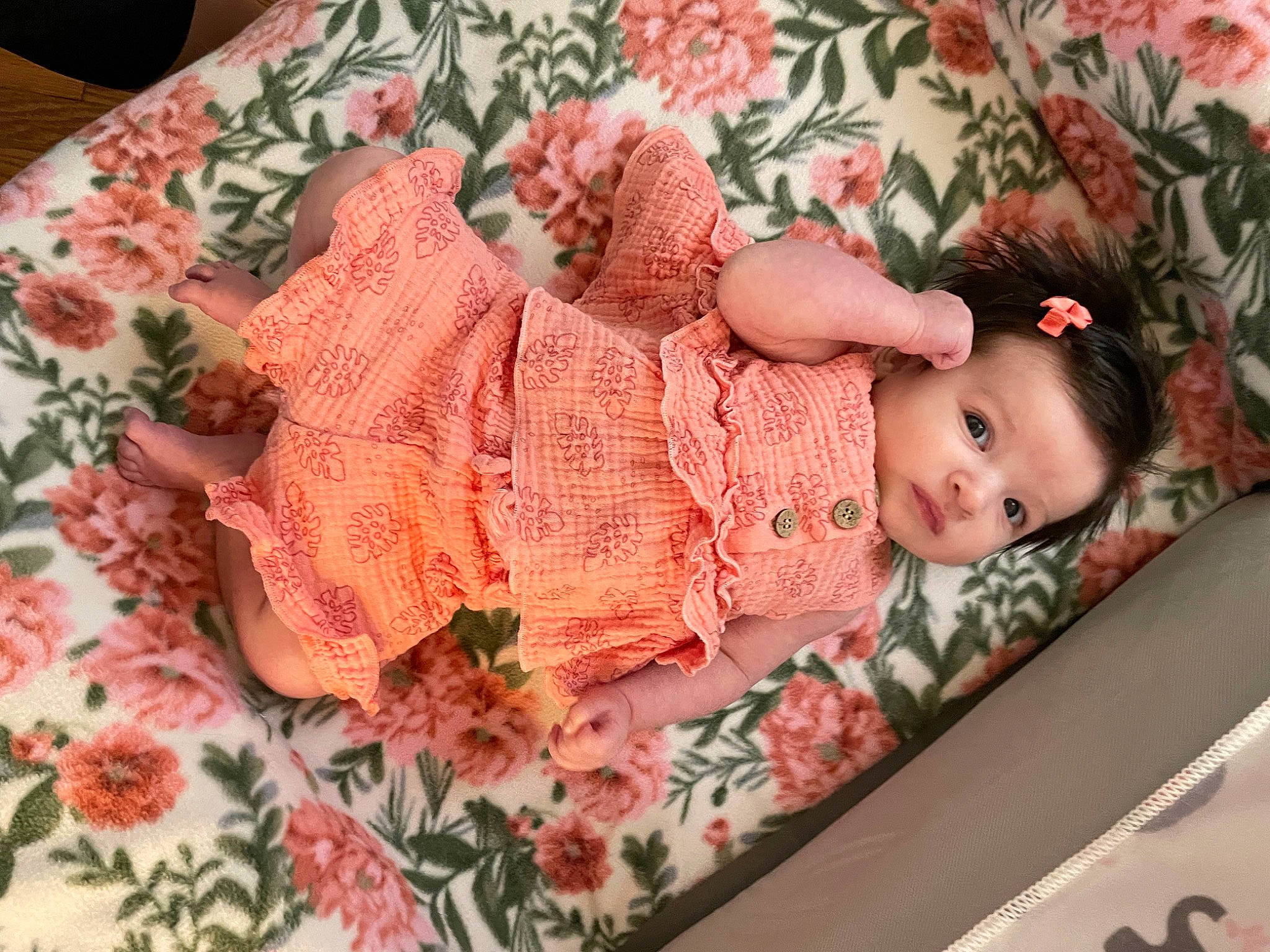 Alexandra is registered to the contest to win money with this photo: art, baby, baby_toddler_clothing, child, creative_arts, doll, dress, embellishment, flooring, hair_accessory, headgear, linens, pattern, peach, person, pink, plant, sleeve, textile, toddler