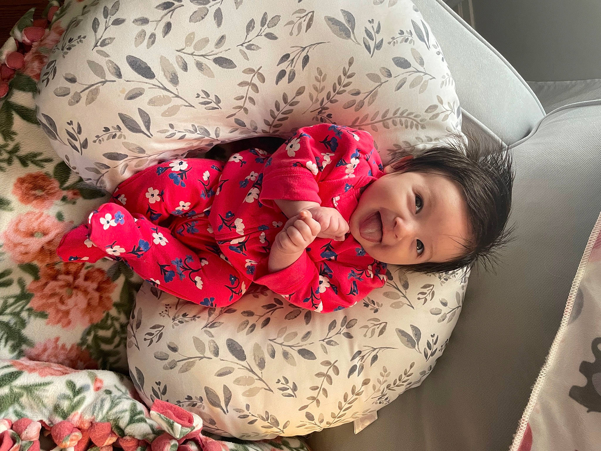 Alexandra is registered to the contest to win money with this photo: baby, baby_toddler_clothing, beauty, bedding, child, comfort, couch, event, face, happy, head, human_leg, lap, linens, pattern, person, room, sitting, sleeve, textile