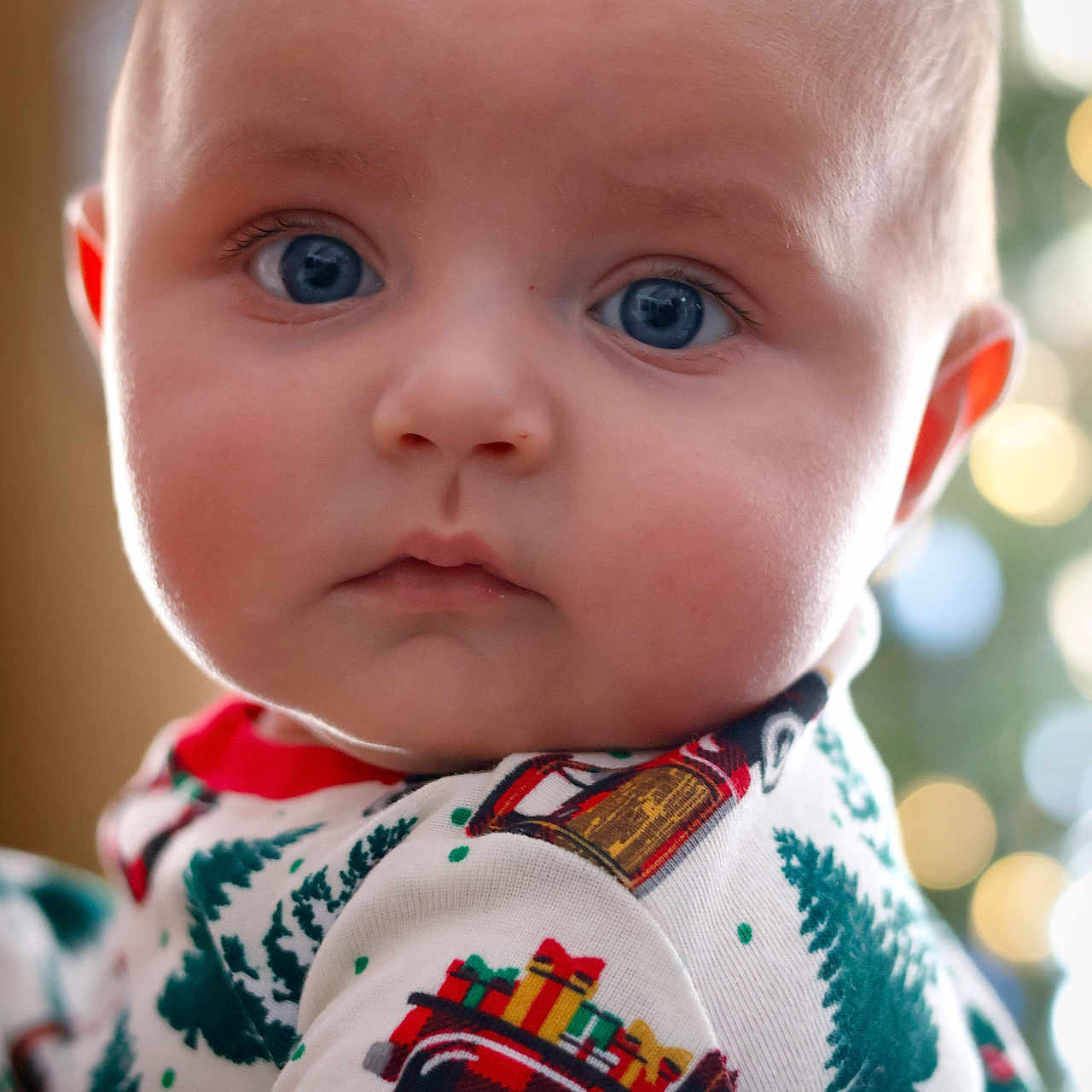 Everett is registered to the contest to win money with this photo: applique, baby, bodypart, clothing, dress, face, fashion, finger, formalwear, frown, hand, head, knitwear, newborn, pattern, person, photography, portrait, sad, sweater