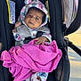 Aliyah joined the competition — help win amazing prizes! baby, infant, car_seat, blanket, onesie, fleece, animal_print, pink, black, straps, clothing, face, person, child, outdoor, sunlight, seat, cute, bundle, expression