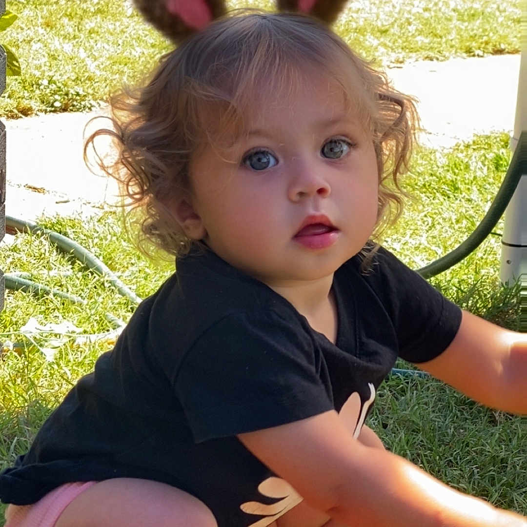 Tia Maree joined the competition — help win amazing prizes! baby, backyard, clothing, face, flower, grass, head, lawn, machine, nature, outdoors, person, photography, plant, portrait, shorts, sitting, summer, wheel, yard