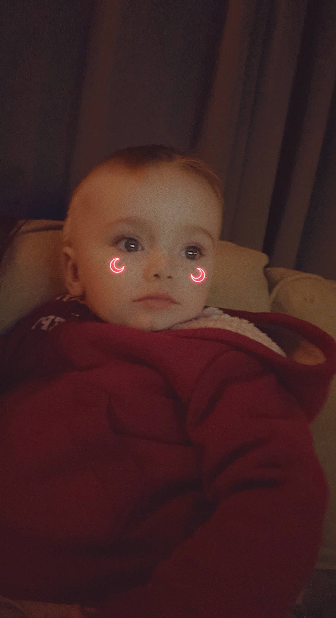 Bryson is registered to the contest to win money with this photo: baby, baby_toddler_clothing, cheek, comfort, darkness, ear, eyelash, flash_photography, flooring, fun, fur, hardwood, iris, lip, nose, person, room, sitting, sleeve, toddler