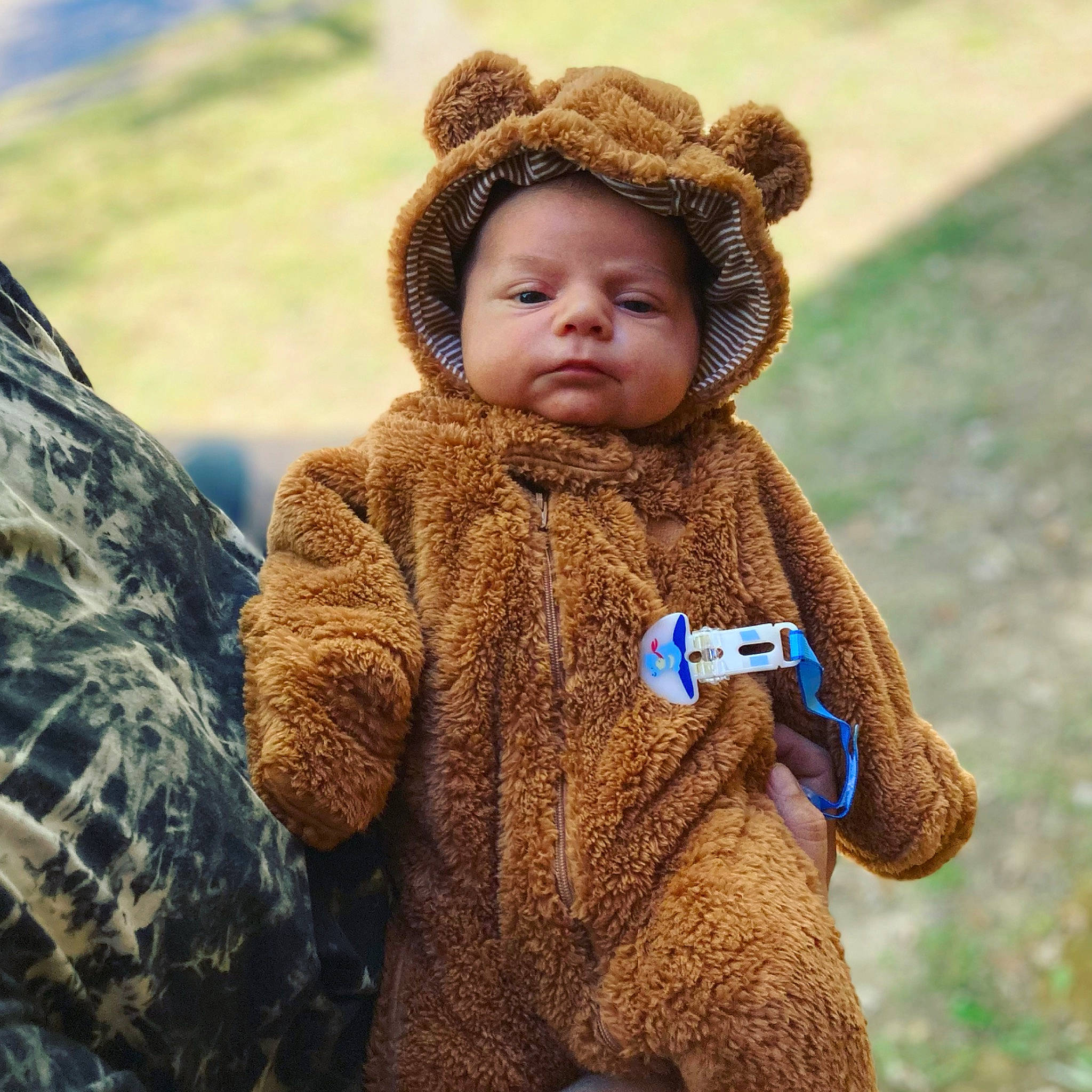 Creed joined the competition — help win amazing prizes! baby, baby_toddler_clothing, cap, eye, fur, gesture, grass, happy, human_body, jacket, landscape, military_camouflage, outerwear, people_in_nature, person, plant, sleeve, textile, toddler, wool