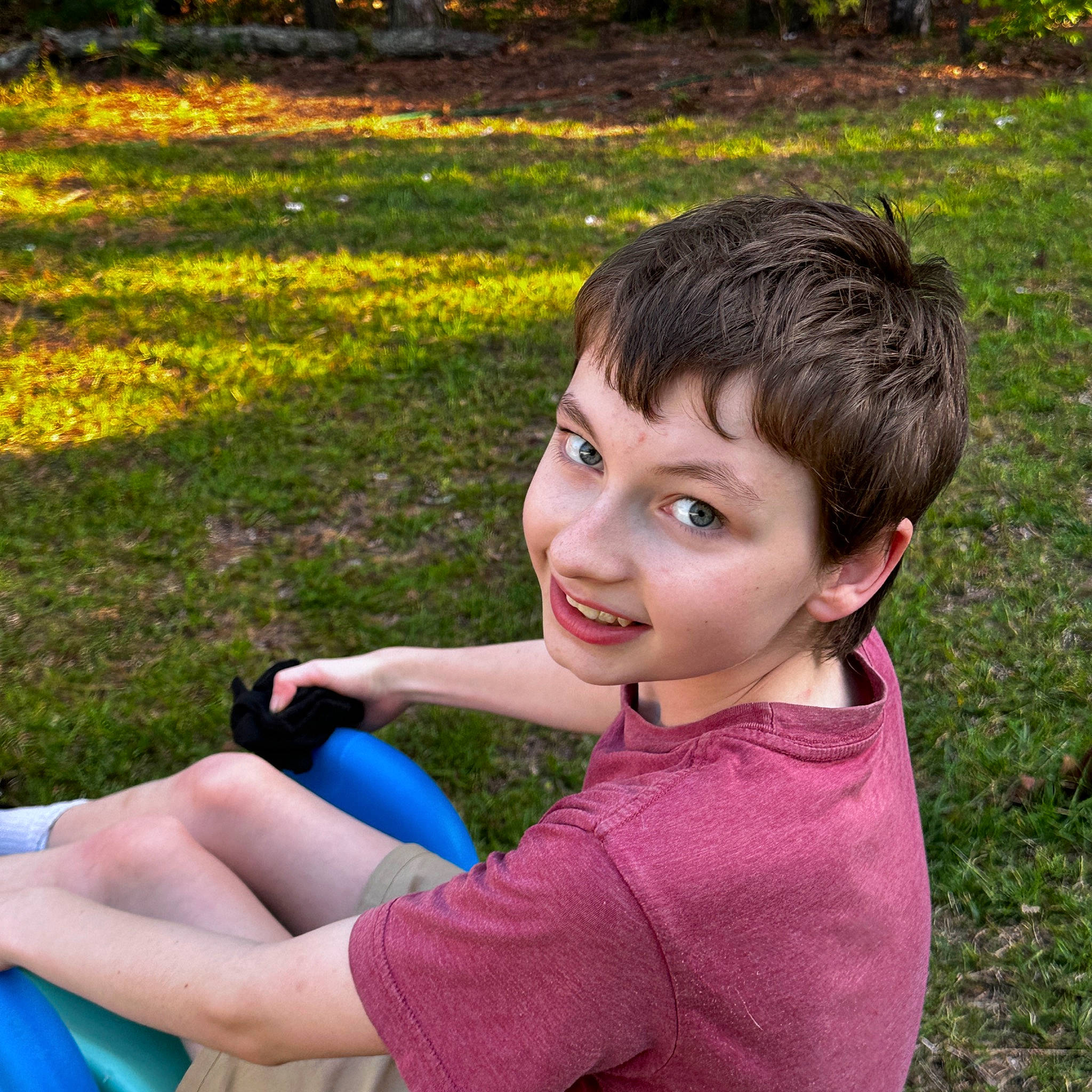 Casey is registered to the contest to win money with this photo: botany, child, electric_blue, fun, grass, grass_family, grassland, happy, joy, lawn, leisure, mobile_phone, nature, people, people_in_nature, person, photograph, plant, recreation, smile