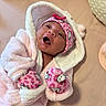 Emanii is registered to the contest to win money with this photo: newborn, baby, infant, child, portrait, smiling, yawning, pink, hooded, blanket, hat, mittens, hello_kitty, fluffy, cozy, indoor, bed, lying_down, cute, face