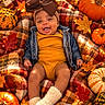 baby, infant, child, smiling, autumn, fall, pumpkins, gourds, leaves, blanket, plaid, bow, headband, orange, portrait, lying_down, outdoor, seasonal, cozy, photography