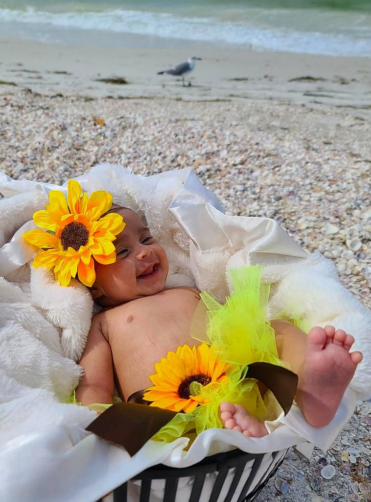 Savannah is registered to the contest to win money with this photo: beach, beauty, bouquet, cut_flowers, dress, finger, flower, flower_arranging, fun, gesture, hand, happy, headwear, joy, people_in_nature, person, petal, photograph, plant, rose