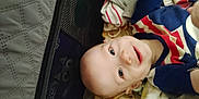 Felix joined the competition — help win amazing prizes! baby, blanket, blue, child, clothing, cute, expression, face, happy, head, indoors, infant, lying_down, person, playpen, red, smiling, soft, white, young