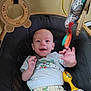 baby, baby_seat, child, clothing, colorful, cute, expression, fabric, face, hand, happy, indoor, infant, pattern, playtime, reaching, seat, smiling, toy, young_child