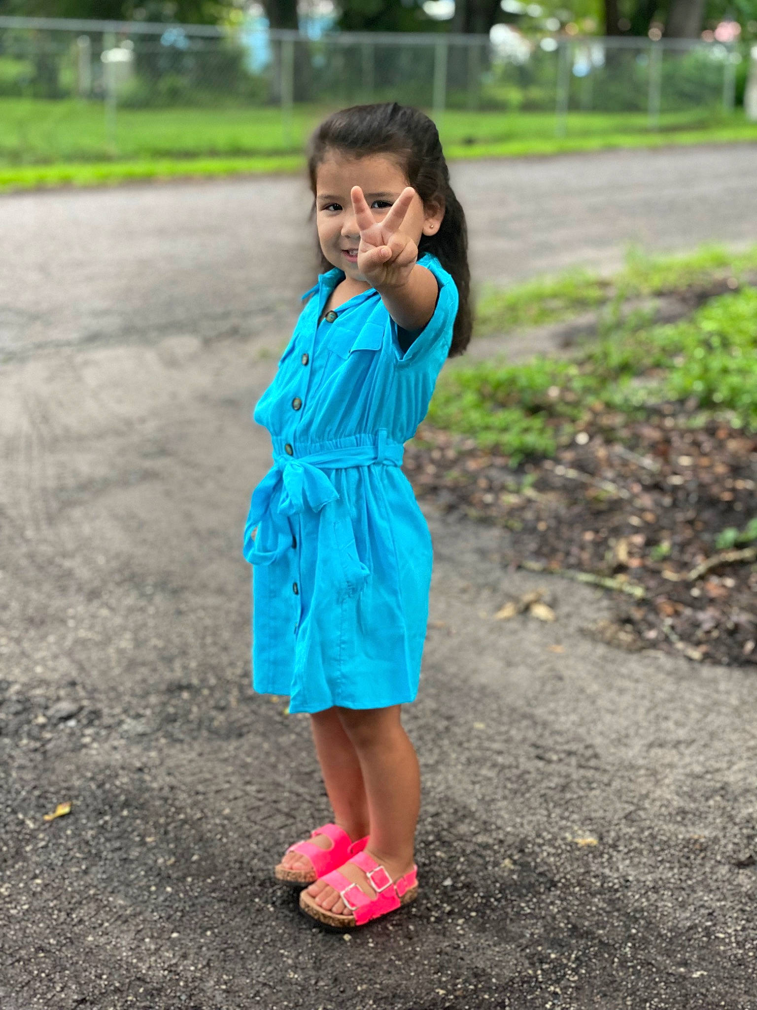 Nessiah is registered to the contest to win money with this photo: asphalt, day_dress, dress, electric_blue, footwear, grass, happy, leaf, leg, leisure, one_piece_garment, people_in_nature, person, pink, plant, recreation, road_surface, sandal, sleeve, tree