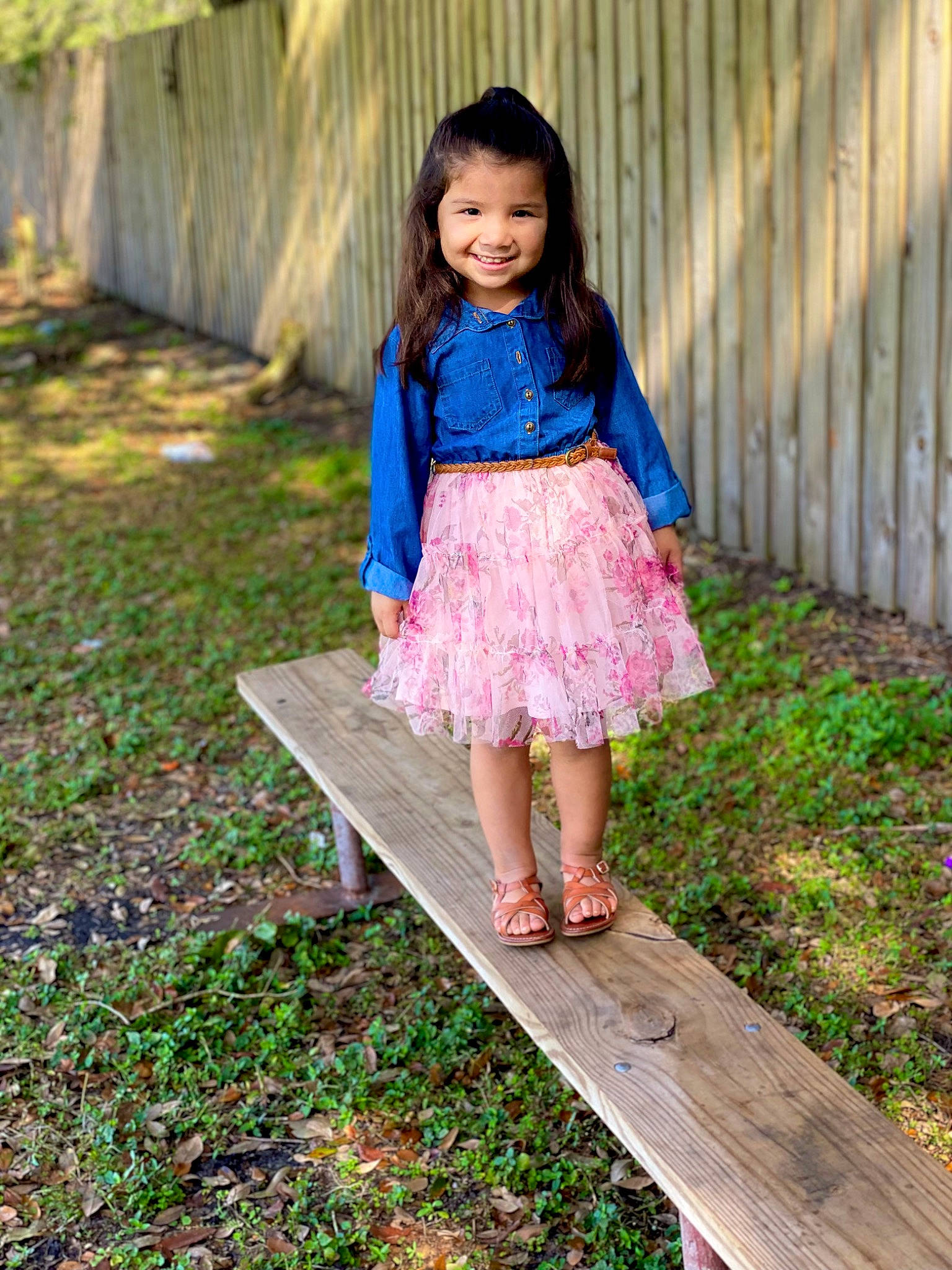 Nessiah is registered to the contest to win money with this photo: brown_hair, child, day_dress, electric_blue, fun, garden, grass, happy, joy, leg, leisure, magenta, pattern, people_in_nature, person, plant, sandal, sitting, smile, spring