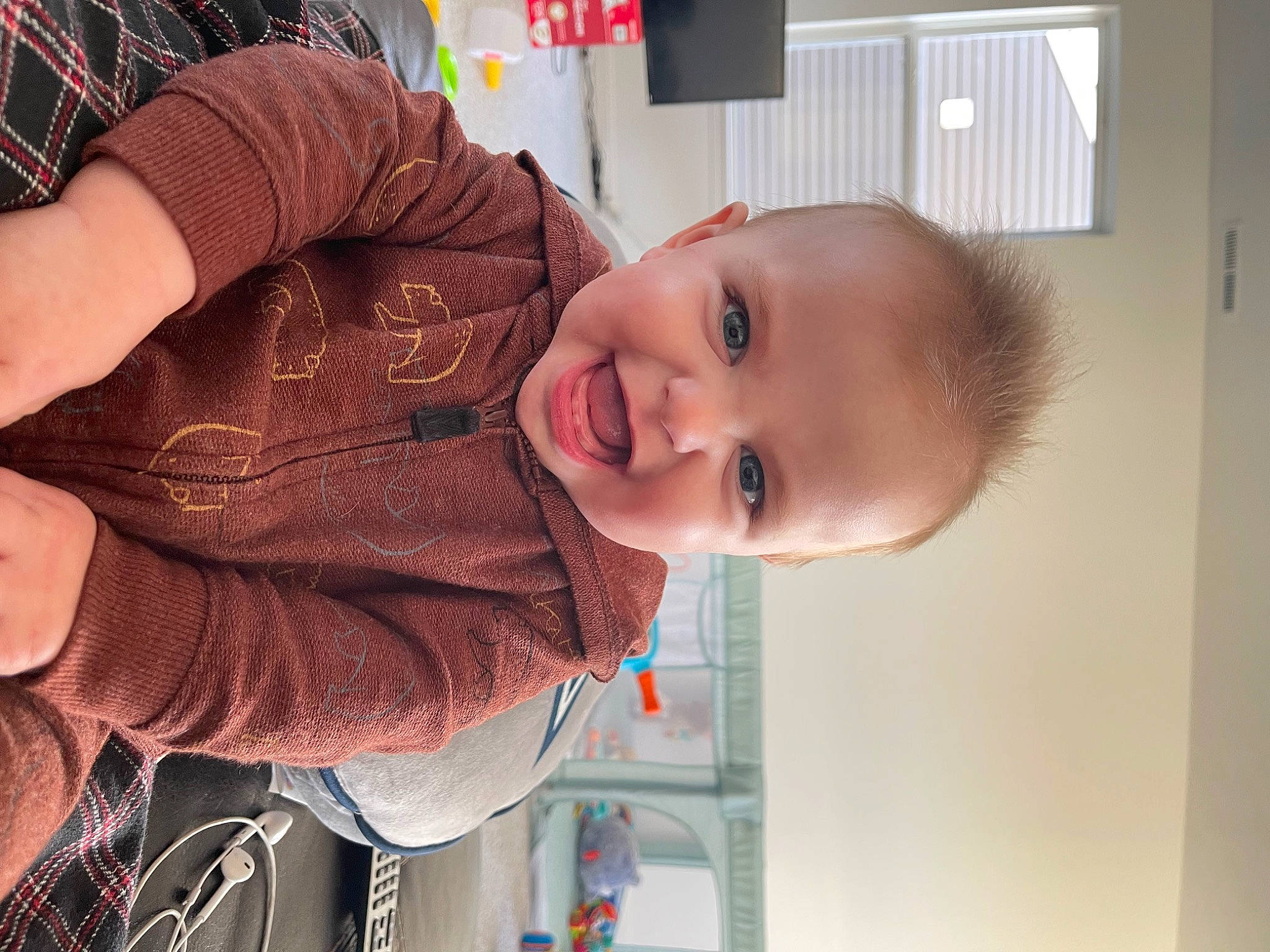 Hudson is registered to the contest to win money with this photo: arm, baby, cheek, chin, ear, eye, finger, fun, gesture, happy, head, human_body, iris, mouth, nose, person, skin, smile, thumb, toddler