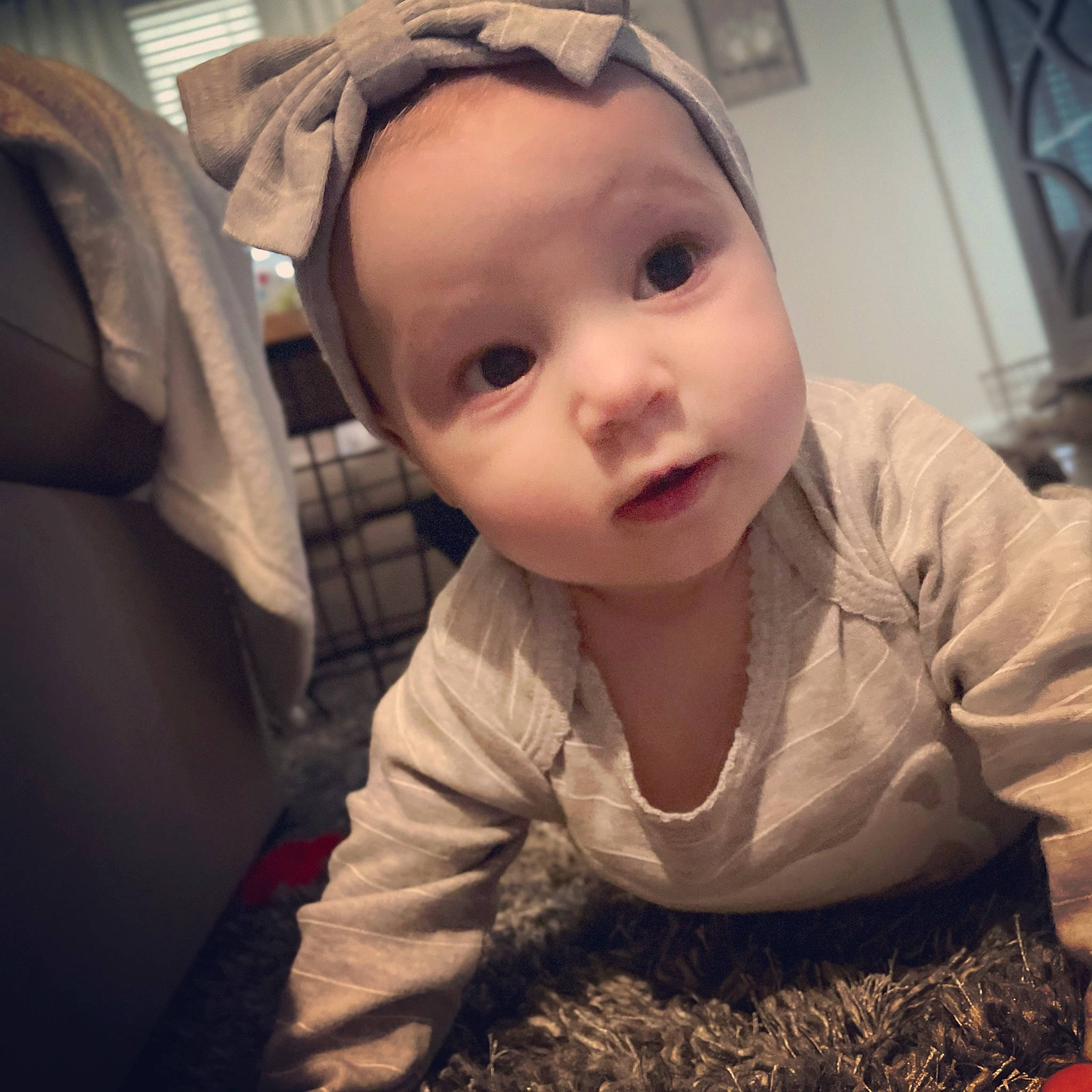 Sloan is registered to the contest to win money with this photo: baby, baby_toddler_clothing, child, cloud, comfort, crawling, eyelash, flooring, fun, happy, human_body, iris, mouth, nose, person, sitting, skin, sleeve, smile, soil