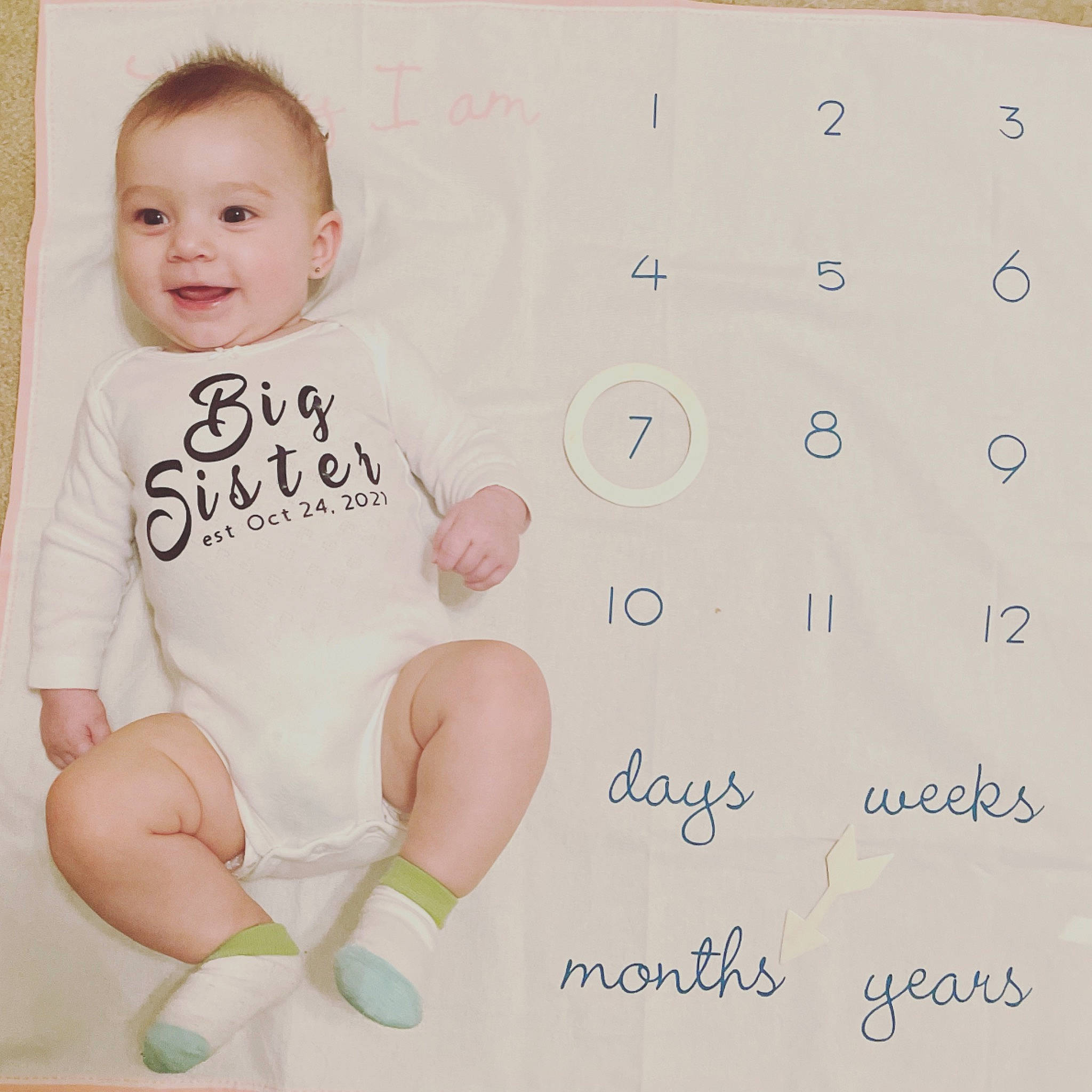 Sloan is registered to the contest to win money with this photo: baby, baby_products, baby_toddler_clothing, cheek, child, circle, design, flooring, font, gesture, happy, joy, linens, logo, magenta, pattern, person, sleeve, smile, t_shirt