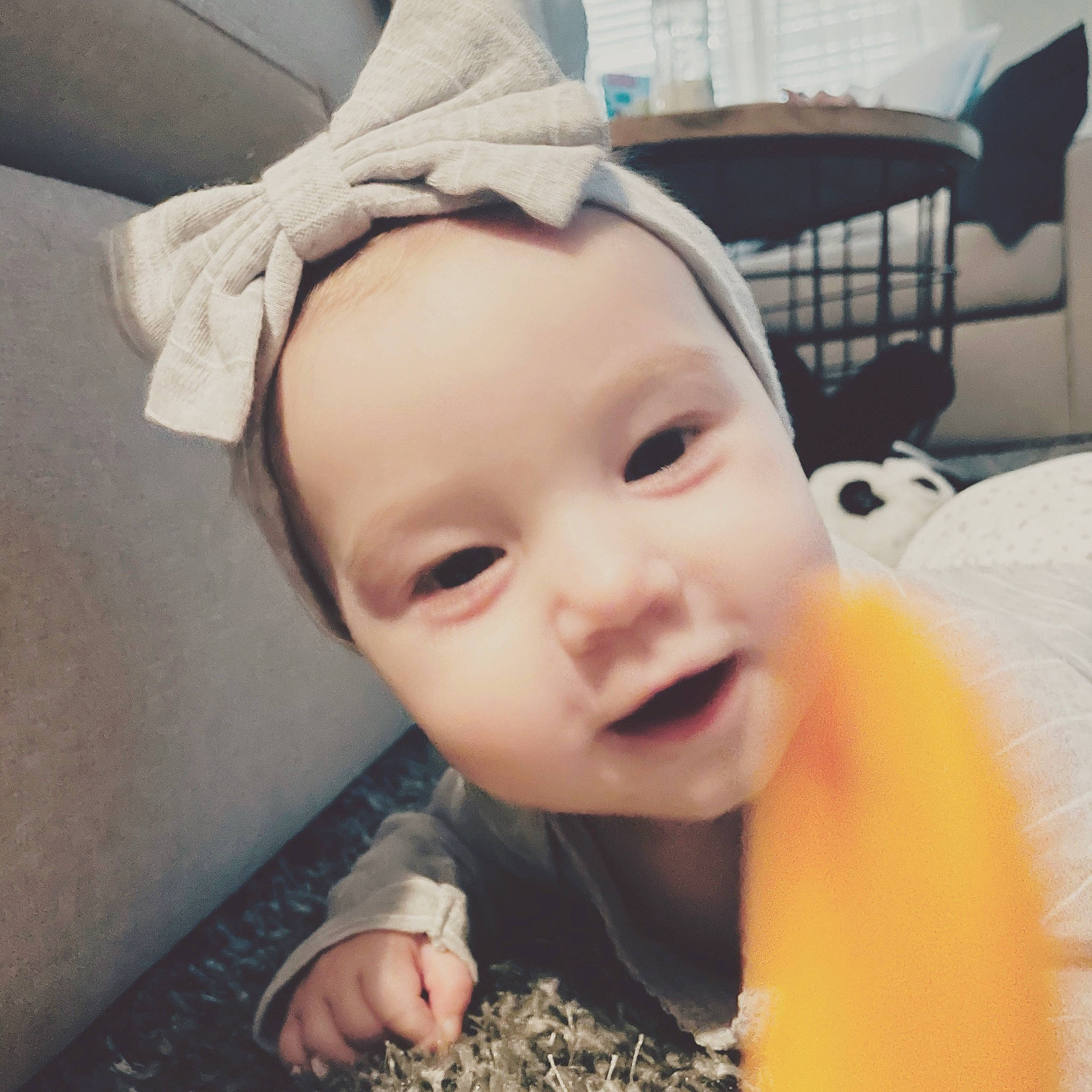 Sloan is registered to the contest to win money with this photo: baby, baby_toddler_clothing, cheek, cloud, ear, eye, eyelash, face, finger, happy, head, headwear, human_body, iris, jaw, lip, neck, nose, person, photograph