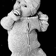 Lou a rejoint le concours — aidez-le/la à gagner de superbes lots ! baby, infant, onesie, hat, bunny_ears, thumb_sucking, carpet, rug, texture, black_and_white, portrait, cute, child, lying_down, cozy_clothing, baby_hat, monochrome, indoor, face, small_person