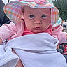 baby, child, hat, pink_clothing, blanket, outdoor, portrait, face, person, cute, infant, wide_eyes, colorful_hat, clothing, looking_at_camera, nature, trees, people, bundle, serious_expression