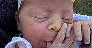 Ember joined the competition — help win amazing prizes! baby, blanket, closeup, cute, face, flower, grass, hand, headband, infant, newborn, newborn_clothing, outdoor, peaceful, person, resting, skin, sleeping, soft_light, thumb_sucking