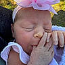 Ember joined the competition — help win amazing prizes! baby, newborn, infant, sleeping, headband, flower, hand, thumb_sucking, blanket, outdoor, grass, skin, face, peaceful, cute, closeup, person, soft_light, newborn_clothing, resting