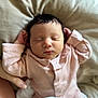 newborn, baby, sleeping, pink_clothing, blanket, infant, hand, soft_texture, cozy, portrait, peaceful, cute, human, child, indoors, resting, face, small_hands, gentle, toddler